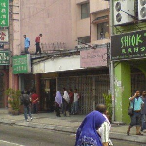 Two men standing on the roof to get a good view of this Bersih 2.0 rally
